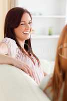 Smiling women relaxing on a sofa