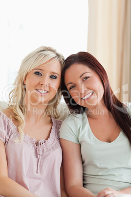 Cheerful women lounging on a sofa