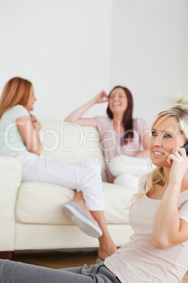 Joyful woman with a phone separated from the others