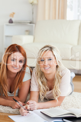 College Students lying on the floor learning