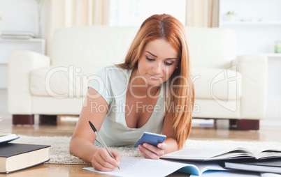 Smiling College Student lying on the floor learning