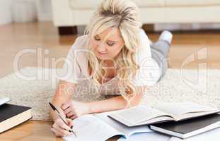Blond College Student lying on the floor learning