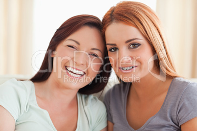 Gorgeous friends sitting on a sofa