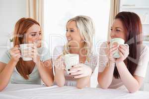 Women sitting at a table with cups
