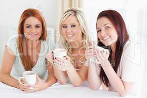 Charming Women sitting at a table with cups