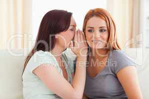Young woman being told a secret