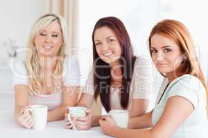 Women sitting at a table drinking coffee