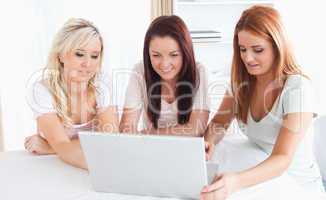 Women sitting at a table with a laptop