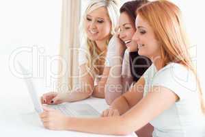Charming Women sitting at a table with a laptop
