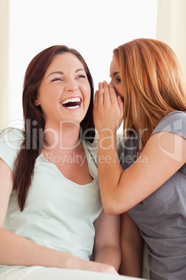 Laughing woman being told something