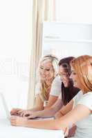Cheerful Women sitting at a table with a laptop