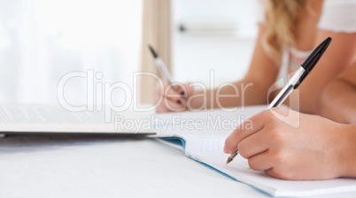 Close up of Students sitting at a table doing their homework