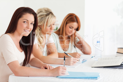 Portrait of charming Students learning at a table