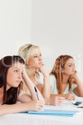 Bored university students sitting at a table