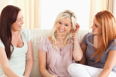 Cheerful friends sitting on a sofa