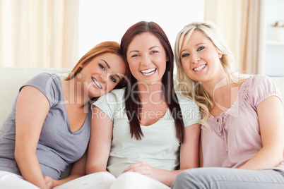 Laughing friends sitting on a sofa