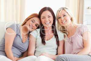 Laughing friends sitting on a sofa