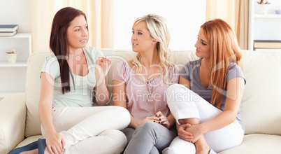 Chatting friends sitting on a sofa