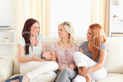Cheering friends sitting on a sofa