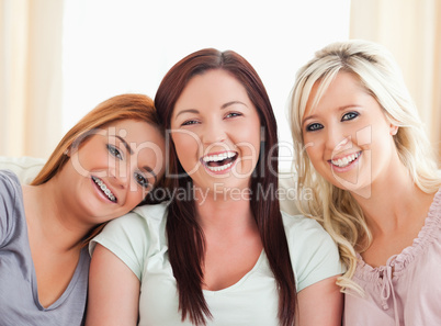 Cheering women sitting on a sofa