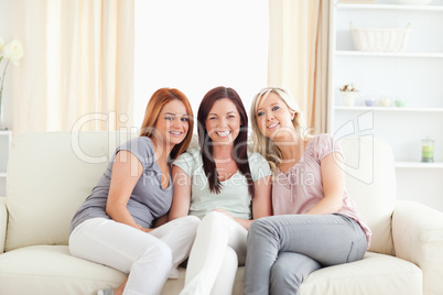Cute young women sitting on a sofa