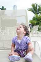 Cute happy one year old baby looking up in a relax place