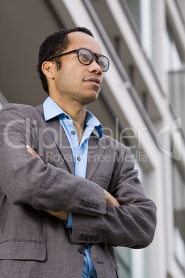 Smart business man with crossed arms out of office