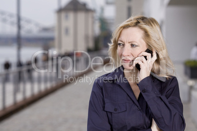 Business female on the phone outdoors