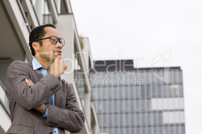 Smart business man with crossed arms out of office