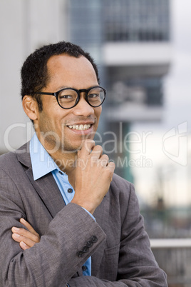 Friendly business guy outside with glasses smiling