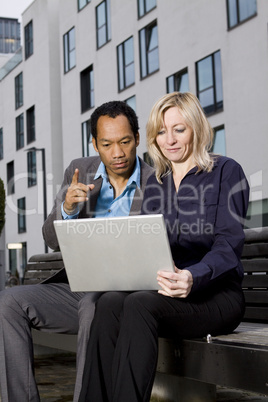 Business couple working outside office