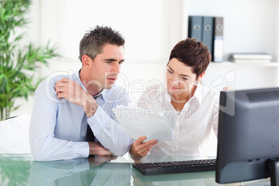 Colleagues looking at folders