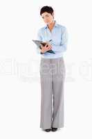 Businesswoman writing on a clipboard