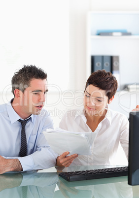 Portrait of colleagues looking at folders