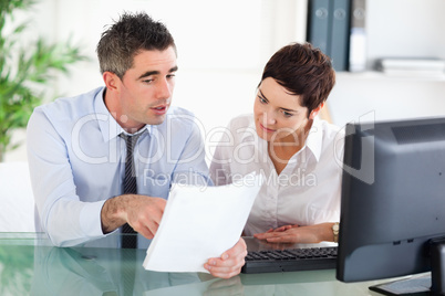 Office workers looking at a document