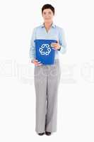 Businesswoman with a recycling bin