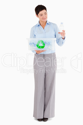 Woman with a plastic bottle and a recycling box