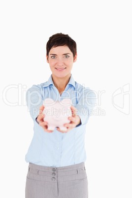 Office worker holding a piggy bank