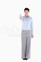 Office worker standing with her thumb up