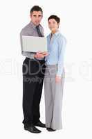 Office workers holding a laptop