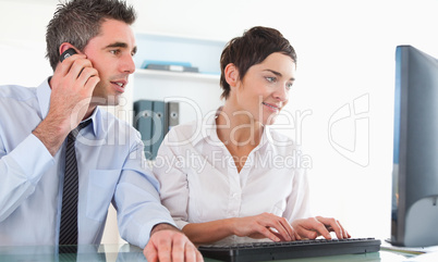 Colleagues using a computer