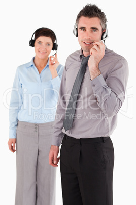 Portrait of office workers using headsets