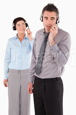 Portrait of office workers speaking through headsets