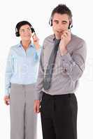 Portrait of office workers speaking through headsets