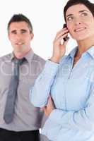 Portrait of a woman on a phone call while her colleague is posin