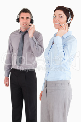 Portrait of managers speaking through headsets