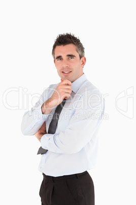 Portrait of a smiling salesperson with his hand on his chin