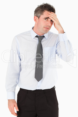 Portrait of a sad business manager with his hand on his forehead