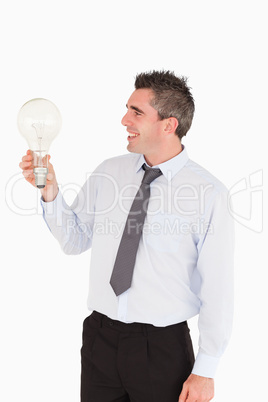 Man looking at a light bulb