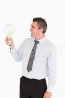 Businessman looking at a light bulb